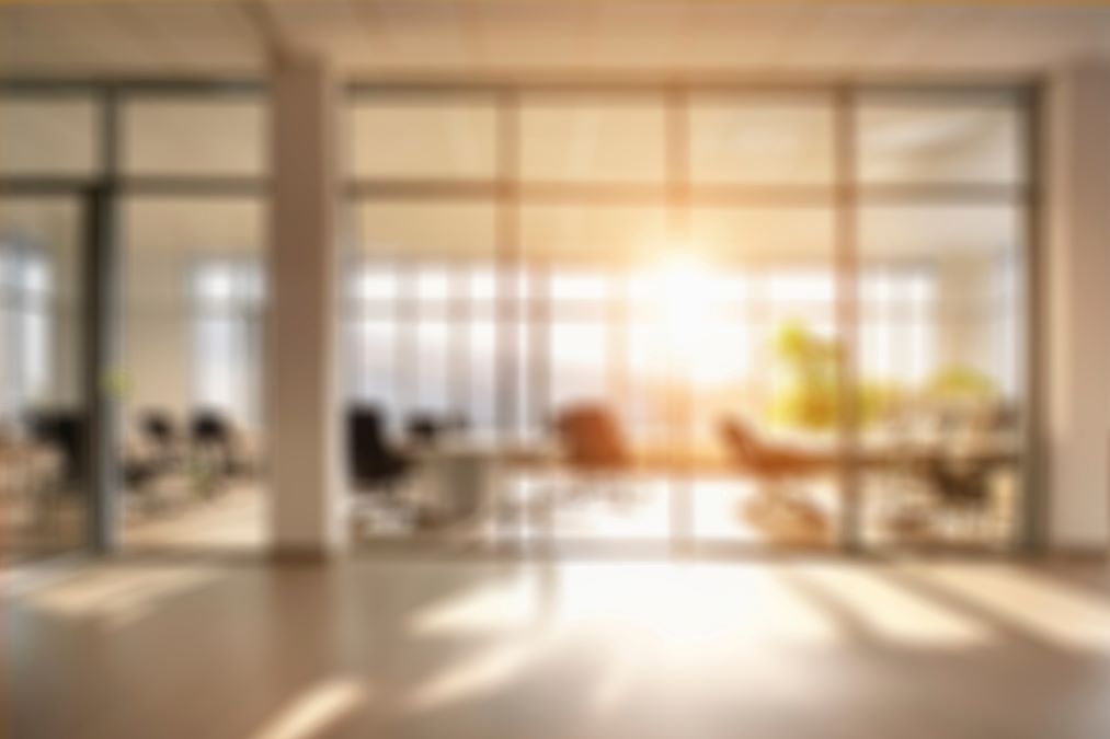 A photo of an empty board room with sun coming through the windows