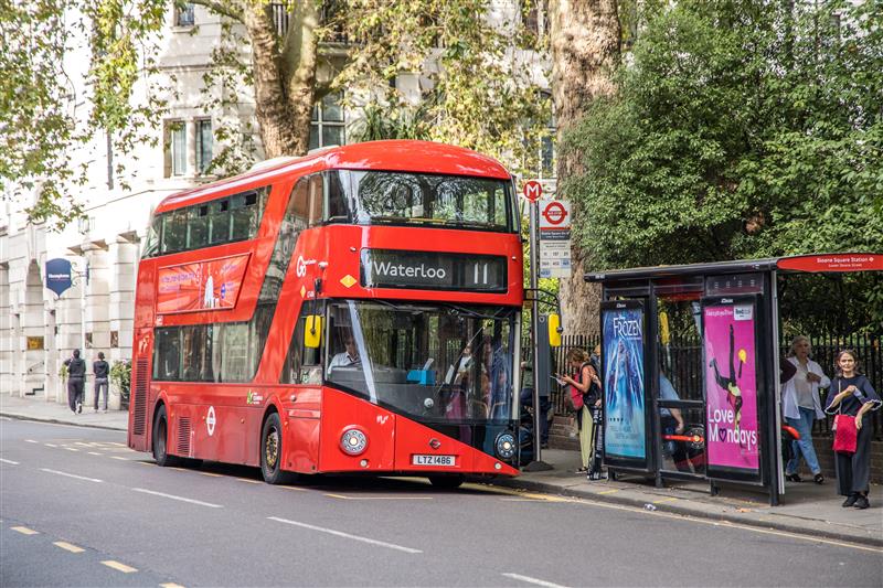 Number 11 bus pulling up to a bus stop